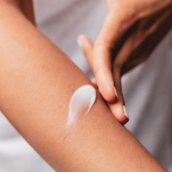 Applying IA skin care cream to arm